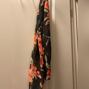 Long scarf with orange and brown tones brighten a fall outfit with ease